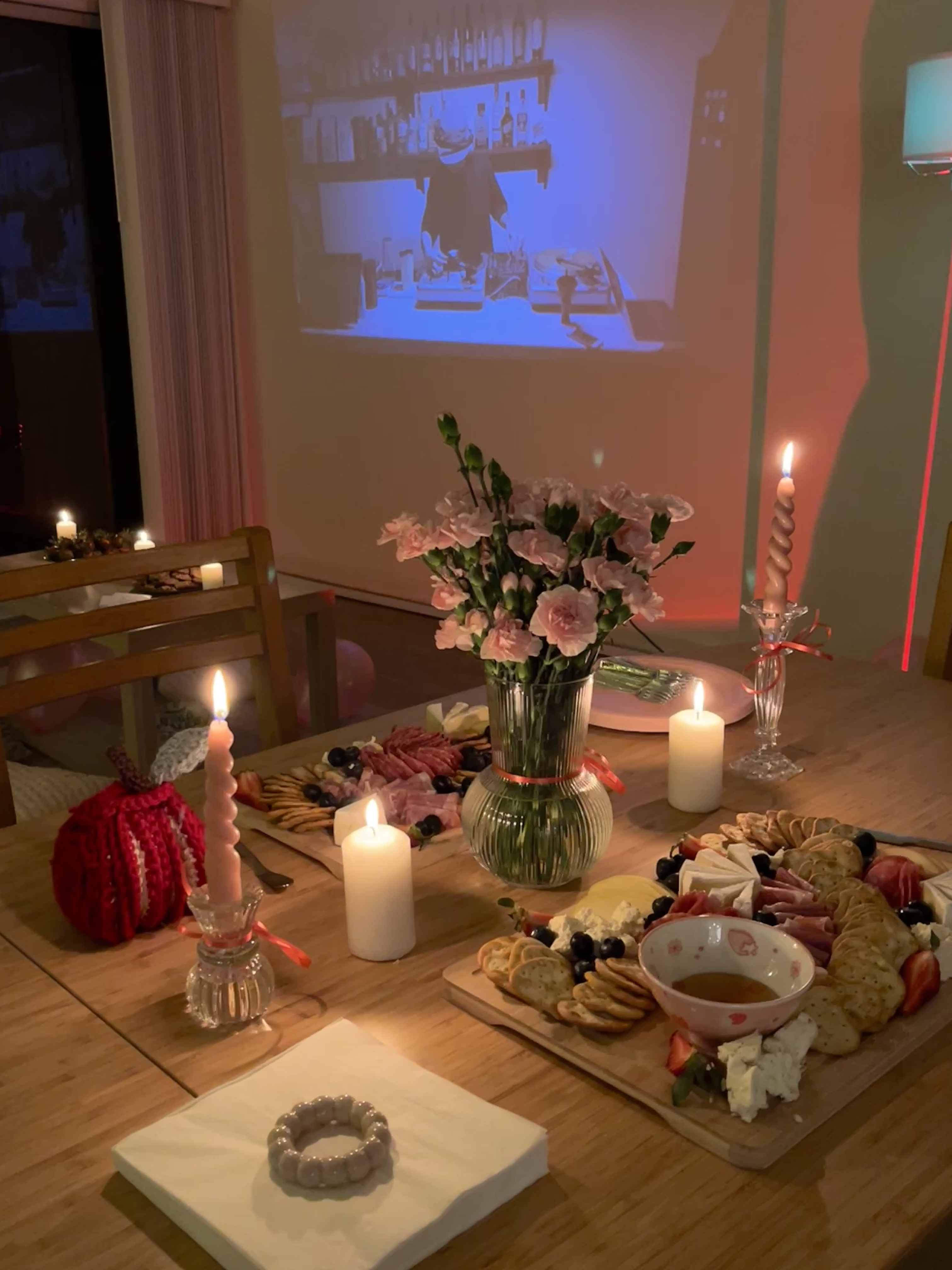 Candlelit dinner table setup with charcuterie board at a club social
