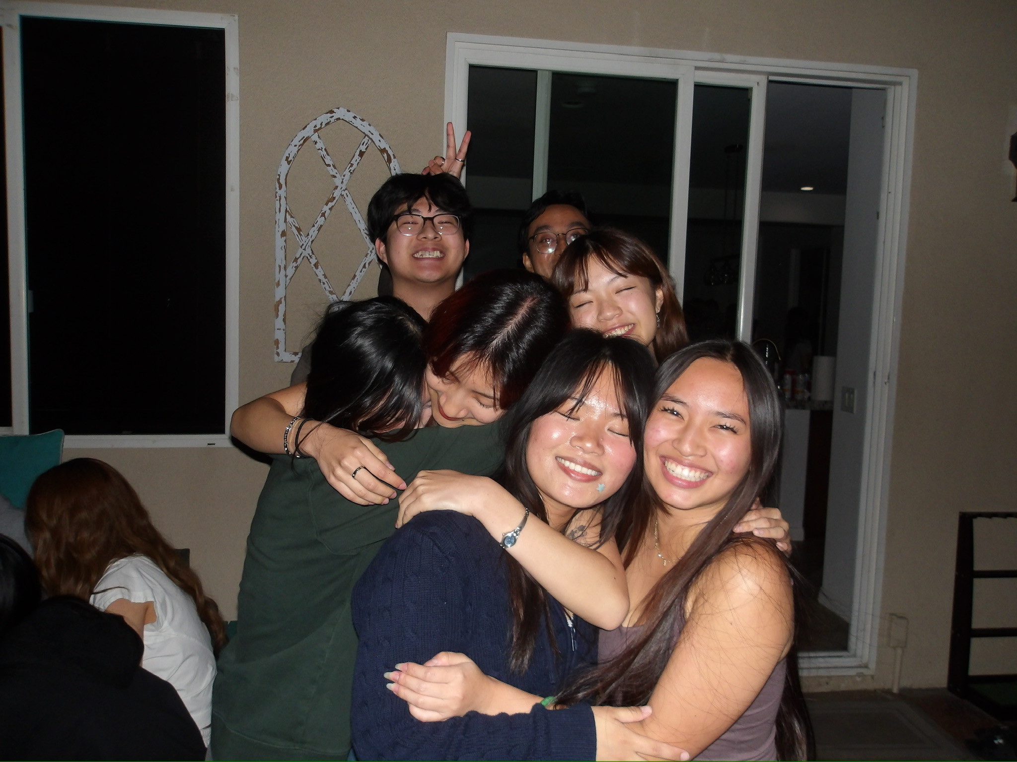 Club members in a group hug at a social event